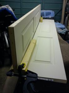 Picture of door panels clamped at 90 degrees to each other to ease planing the sawn edge